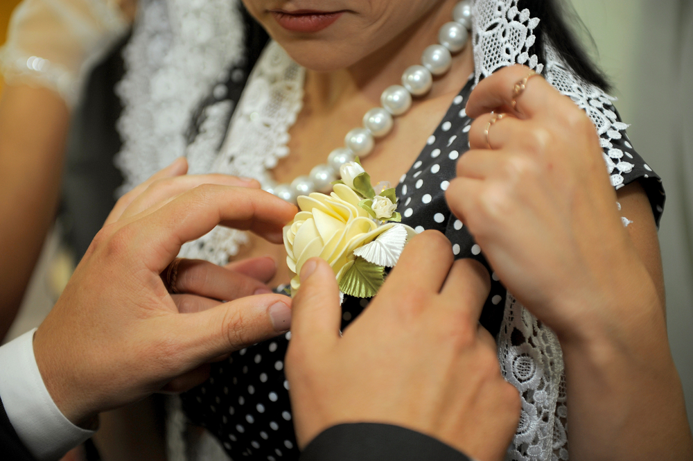 About how far up or down should the corsage be pinned